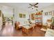 Cozy living room with hardwood floors, ceiling fan, and comfortable seating at 10697 Acacia Park Pl, Las Vegas, NV 89135