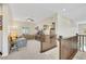 Upstairs living room with a cozy sofa and entertainment center at 10697 Acacia Park Pl, Las Vegas, NV 89135