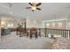 Spacious loft area with seating and multiple ceiling fans at 10697 Acacia Park Pl, Las Vegas, NV 89135