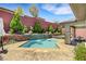Inviting backyard pool featuring stone accents, a waterfall feature, and ample patio space for outdoor enjoyment at 10697 Acacia Park Pl, Las Vegas, NV 89135
