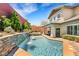 Inviting pool with a waterfall feature and landscaped surroundings at 10697 Acacia Park Pl, Las Vegas, NV 89135