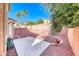 The backyard has red rock landscaping, a small patio, and a privacy wall at 11028 Meadow Leaf Ave, Las Vegas, NV 89144
