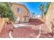 The backyard has red rock landscaping, a privacy wall, and a small patio at 11028 Meadow Leaf Ave, Las Vegas, NV 89144