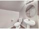 Cozy bathroom features a pedestal sink, toilet, and hardwood-style floors at 11028 Meadow Leaf Ave, Las Vegas, NV 89144