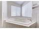 Bathroom with corner soaking tub and tiled surround at 11028 Meadow Leaf Ave, Las Vegas, NV 89144