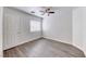 Well-lit bedroom with a ceiling fan, window, and wood-look flooring at 11028 Meadow Leaf Ave, Las Vegas, NV 89144