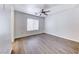Large bedroom with hardwood floors, ceiling fan, and a window at 11028 Meadow Leaf Ave, Las Vegas, NV 89144