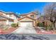 Charming two-story home featuring a two-car garage, landscaped yard, and desert landscaping at 11028 Meadow Leaf Ave, Las Vegas, NV 89144