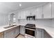 A close-up view of a renovated kitchen with quartz countertops, stainless appliances, and subway tile at 11028 Meadow Leaf Ave, Las Vegas, NV 89144