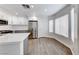 A renovated kitchen includes quartz countertops, stainless appliances, subway tile, and wood-look flooring at 11028 Meadow Leaf Ave, Las Vegas, NV 89144