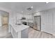 Renovated kitchen featuring quartz countertops, stainless steel appliances, and wood-look flooring at 11028 Meadow Leaf Ave, Las Vegas, NV 89144