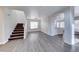 Open-concept living room with hardwood floors, staircase, and bright natural light at 11028 Meadow Leaf Ave, Las Vegas, NV 89144