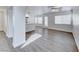 Spacious living area featuring wood-look flooring, fresh paint, and view of modern kitchen at 11028 Meadow Leaf Ave, Las Vegas, NV 89144