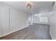 Open-concept living area with high ceilings, hardwood floors, and modern light fixture at 11028 Meadow Leaf Ave, Las Vegas, NV 89144