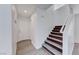Hallway leading to staircase with wood steps and white banister at 11028 Meadow Leaf Ave, Las Vegas, NV 89144