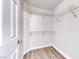 Bright walk-in closet with built-in wire shelving and wood-look flooring at 11028 Meadow Leaf Ave, Las Vegas, NV 89144