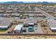 Drone shot of a home in a neighborhood with a garage, hot tub, and gazebo at 111 Magnolia Blvd, Pahrump, NV 89048