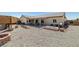 Desert landscaped backyard with covered patio at 111 Magnolia Blvd, Pahrump, NV 89048