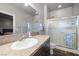 Bright bathroom with a large mirror, granite counters, and a glass-enclosed shower at 111 Magnolia Blvd, Pahrump, NV 89048
