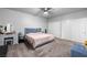 Neutral bedroom featuring soft carpet, ceiling fan, and double-door closets at 111 Magnolia Blvd, Pahrump, NV 89048