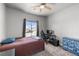 Cozy bedroom with carpeted floors, a ceiling fan and view of the neighborhood at 111 Magnolia Blvd, Pahrump, NV 89048