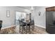 Bright dining area features wood floors, a modern table set, and sliding glass doors to a patio at 111 Magnolia Blvd, Pahrump, NV 89048