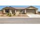 Charming single-story home with desert landscaping and a two-car garage at 111 Magnolia Blvd, Pahrump, NV 89048