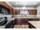 Updated kitchen showcasing dark cabinetry, countertops, modern appliances, and an adjacent dining space at 111 Magnolia Blvd, Pahrump, NV 89048