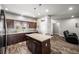 Beautiful kitchen with an island, dark wood cabinets, stainless steel appliances, and wood-look flooring at 111 Magnolia Blvd, Pahrump, NV 89048