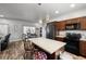 Modern kitchen featuring dark wood cabinets, stainless steel appliances, and an island with bar stool seating at 111 Magnolia Blvd, Pahrump, NV 89048