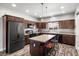 Gorgeous kitchen with a large island, dark wood cabinets, stainless steel appliances, and modern pendant lighting at 111 Magnolia Blvd, Pahrump, NV 89048