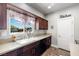 Close up of a kitchen sink, window, and faucet in a well lit kitchen at 111 Magnolia Blvd, Pahrump, NV 89048