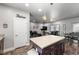 Open concept kitchen with island, stainless appliances, and flows to dining and living areas at 111 Magnolia Blvd, Pahrump, NV 89048