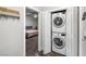 Conveniently located laundry area adjacent to a bedroom featuring a stacked washer and dryer at 111 Magnolia Blvd, Pahrump, NV 89048