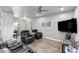 Comfortable living room with leather furniture, a ceiling fan and wood-look floors at 111 Magnolia Blvd, Pahrump, NV 89048