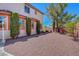 View of backyard featuring decorative rock, stucco wall, and side entry at 11444 Steponia Bay St, Las Vegas, NV 89141