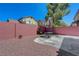 Private backyard featuring a seating area, surrounded by a brick wall for added seclusion at 11444 Steponia Bay St, Las Vegas, NV 89141