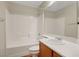 Clean, well-lit bathroom featuring white tile, vanity and a shower-tub combo at 11444 Steponia Bay St, Las Vegas, NV 89141