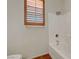 Well-lit bathroom featuring tiled shower and shuttered window at 11444 Steponia Bay St, Las Vegas, NV 89141