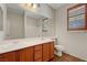Well-lit bathroom with double sinks, large mirror, and tiled floor at 11444 Steponia Bay St, Las Vegas, NV 89141