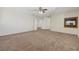Spacious carpeted bedroom featuring a ceiling fan and fireplace at 11444 Steponia Bay St, Las Vegas, NV 89141