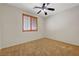 This cozy bedroom features a ceiling fan and a window with wood-look blinds at 11444 Steponia Bay St, Las Vegas, NV 89141