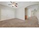 Large bedroom with carpet floors, closet, and open door to hallway at 11444 Steponia Bay St, Las Vegas, NV 89141
