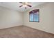 Bright bedroom with carpet, window with shutters, and ceiling fan at 11444 Steponia Bay St, Las Vegas, NV 89141