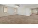 Large carpeted bedroom with two shuttered windows and a ceiling fan at 11444 Steponia Bay St, Las Vegas, NV 89141