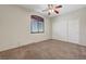Comfortable bedroom featuring neutral carpeting, shuttered window, and double closet at 11444 Steponia Bay St, Las Vegas, NV 89141