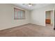 Spacious bedroom with neutral carpeting, plantation shutters, and ceiling fan at 11444 Steponia Bay St, Las Vegas, NV 89141
