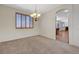 Inviting dining room featuring carpet, neutral paint, and window with plantation shutters at 11444 Steponia Bay St, Las Vegas, NV 89141