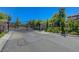 Private, gated entry to the community with manicured landscaping and elegant stone pillars at 11444 Steponia Bay St, Las Vegas, NV 89141