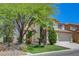 Charming two-story home with stucco exterior, well-manicured lawn, and a two car garage at 11444 Steponia Bay St, Las Vegas, NV 89141